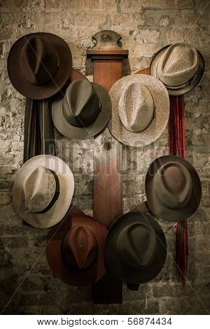 Wall hanger with a a different hats on it 
