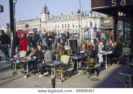 PARIS, FRANCE - MARCH 3, 2013: Parisian street cafe during winter / early spring. Saint Severin on the Boulevard Saint-Michel, 6th arrondissement, left bank of the Seine