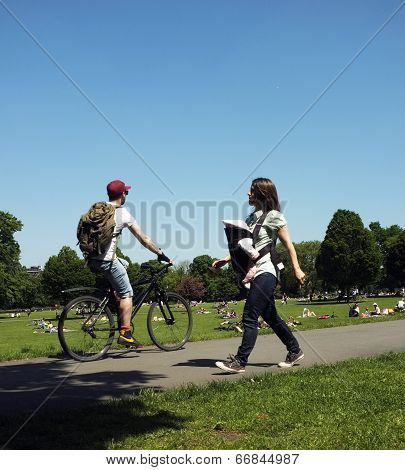 Cyclist and mother with her baby in a park