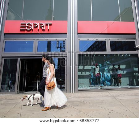 BERLIN, GERMANY - JUNE 11, 2014: Pedestrians walk past an Esprit Holdings Limited clothing store in  Berlin, Germany, on Saturday, June 11, 2014