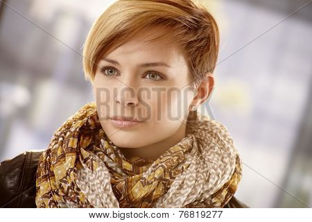 Closeup portrait of young woman in scarf on a spring day