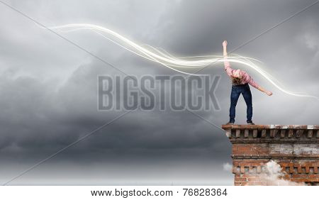 Young guy in casual evading from light rays