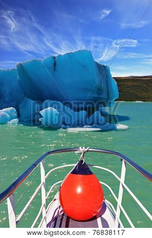Ice and sun Patagonia. Excursion on the tourist boat on Lake Viedma.  White-blue huge icebergs float near a ship board