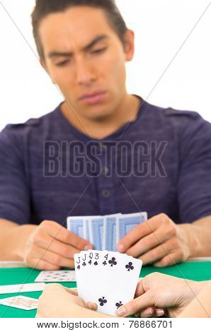 young man playing cards cuarenta traditional Ecuadorian game