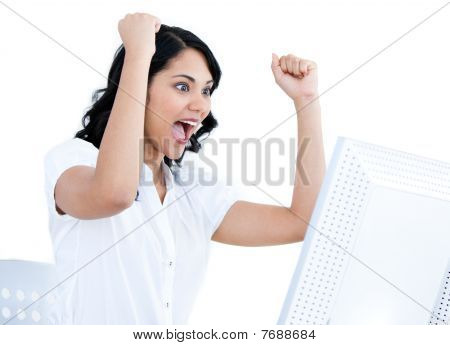Enthusiastic Businesswoman Punching The Air In Front Of Her Computer
