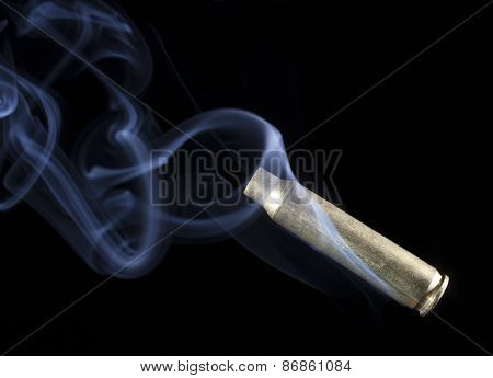 Rifle Casing With Smoke After A Shot