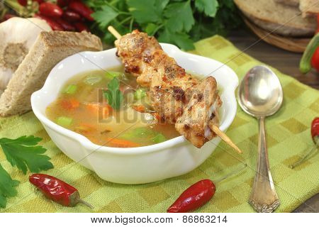 Poultry Consomme With Chicken Skewers And Parsley