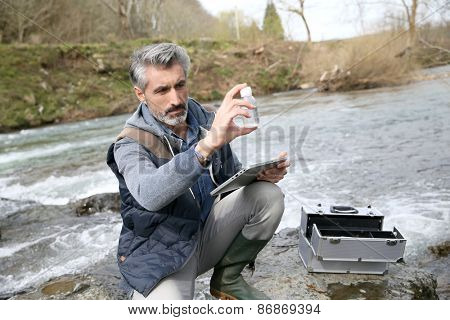 Biologist testing quality of natural water