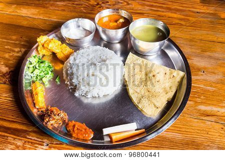 Delicious Nepali Thali meal set with chicken curry