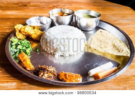 Delicious Nepali Thali meal set with chicken curry