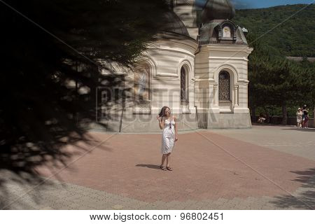 Beautiful young woman on white dress floating in lake