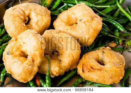 Uluntu Vadai with green chili pepper, a popular Southern Indian deep fried snack