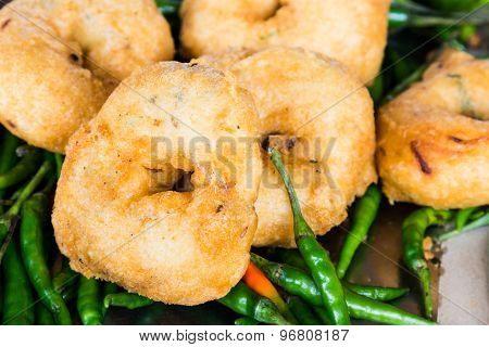 Uluntu Vadai with green chili pepper, a popular Southern Indian deep fried snack