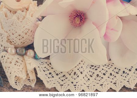 magnolia flowers with pearls on wooden table