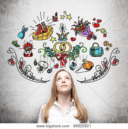 Young Woman Is Dreaming About Sopping. Colourful Shopping Icons Are Drawn On The Wall. Concrete Back