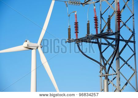 Windmill for electric power production and pylon, La Muela, Zaragoza Province, Aragon, Spain.