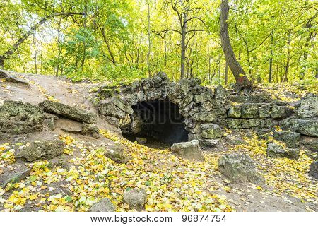 Stone grotto in the autumn park