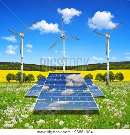 Solar energy panels with wind turbines in spring landscape