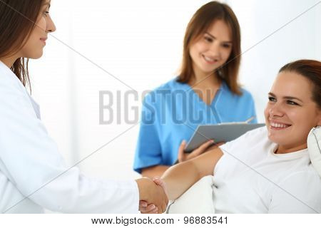 Female Doctor Shaking Hands With Patient