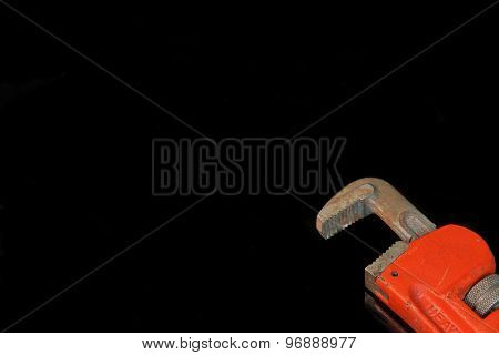 Large Adjustable Wrench With Red Handle Isolated On Black