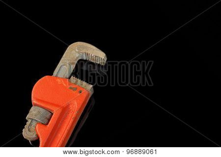 Large Adjustable Wrench With Red Handle Isolated On Black