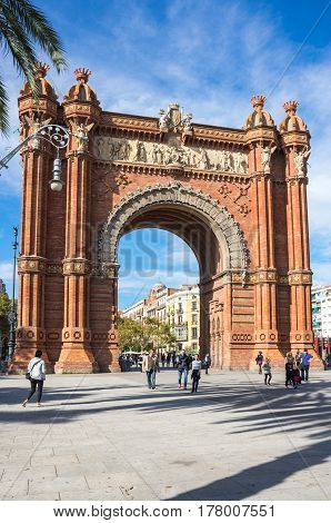 BARCELONA SPAIN - OCTOBER 22 2015: The Arc de Triomf is a triumphal arch in the city of Barcelona in Catalonia Spain. The arch is built in reddish brickwork in the Neo-Mudejar style