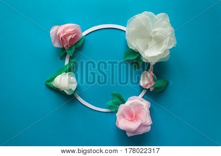 Round Frame With Color Paper Flowers On The Blue Background. Flat Lay. Nature Concept