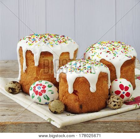 Easter Composition Of Sweet Bread, Paska And Eggs On Light Wooden Background. Orthodox Kulich. Holid