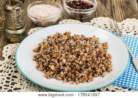 Buckwheat porridge with butter on plate. Studio Photo