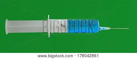 Isolated syringe with needle with blue liquid on green background