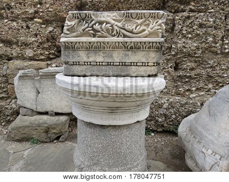 Part of the ancient columns and friezes on the ruins of the ancient city of Side