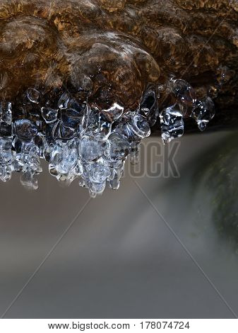 Icicles Above Freeze Winter Mountain Stream. Winter Season At River