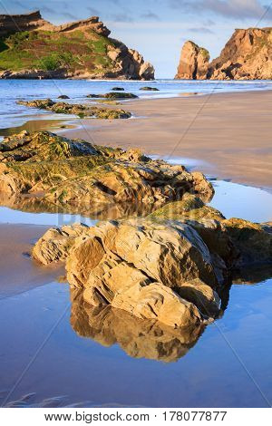 sea, rocks and hills landscape, location - Castlepoint lighthouse, North Island, New Zealand