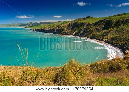 green hills and sea landscape, location - Castlepoint, North Island, New Zealand