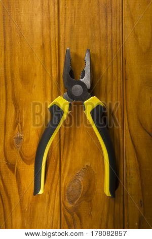 Close up of a multitool pliers on wooden background