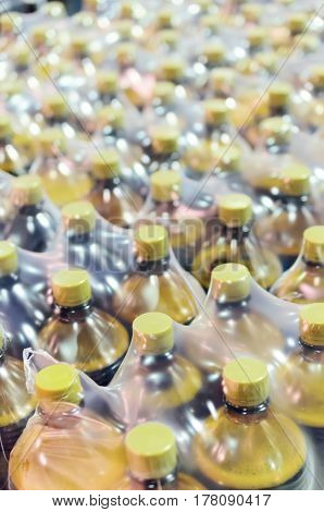Packaging many plastic bottles at the brewery. Packed shrink packaging film.