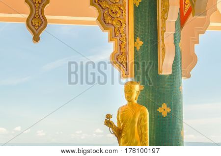 Statue of Buddha standing in Thai temple