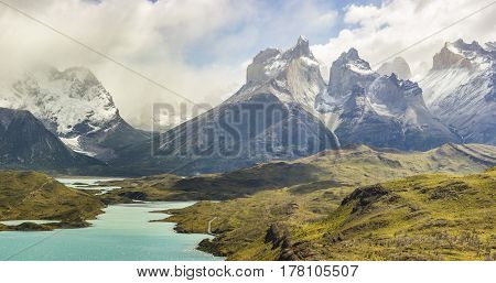 mountains torres del payne in patagonia in fog at sunrise near blue lake pehoe