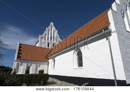 Closeup old traditional Danish white village church in Fons on Funen.