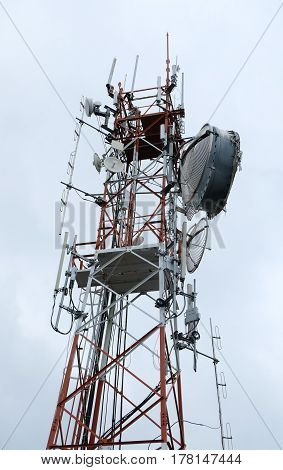 Communication antenna tower with gray sky background