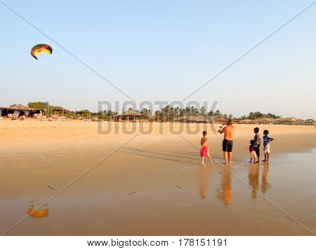 Tourist Making Fly A Kite On The Beach Of Candolim