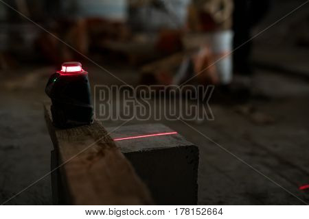 Electronic floor flatness meter with red light in studio being repaired