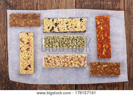 Various muesli / granola / fruit bars with nuts cereals dried berries. Healthy energy snack. Top view.