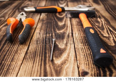 a pliers hammer nail and adjustable wrench