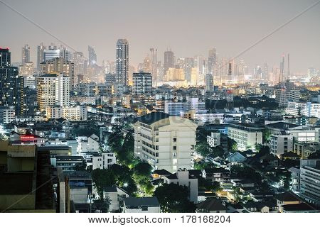 Illuminated night Bangkok city background. Close up