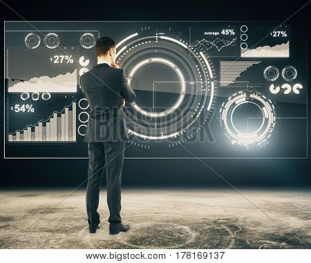 Back view of thoughtful businessperson standing in front of digital business panel. Financial growth concept. Toned image. 3D Rendering