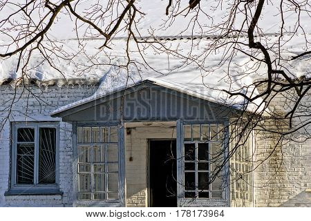 Brick building in the yard with snow