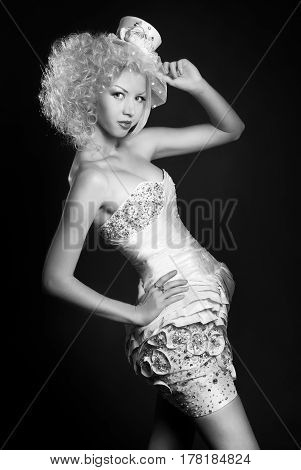 black and white portrait of blonde girl in evening dress and a bowler hat with a veil