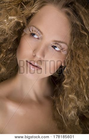 portrait of beautiful curly girl on a beige background