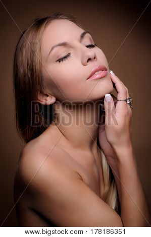 Portrait of beautiful woman on beige background